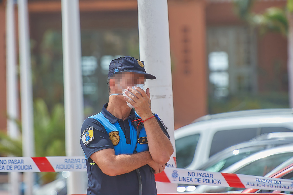 Un policu00eda se protege con una mascarilla mientras custodia el Hotel H10 Costa Adeje Palace