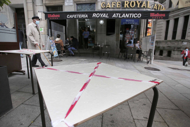 Una mesa de una terraza tachada con una cinta de prohibición en una calle de Vigo el día en que entran en vigor nuevas medidas en la hostelería, en Vigo, Pontevedra, Galicia, (España). La Xunta ha decretado desde este viernes a las 00.00 el paso de la ciu