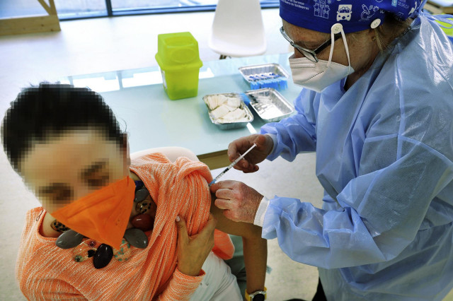 Una mujer recibe una dosis de la vacuna de AstraZeneca en el Complejo Hospitalario Universitario de Ourense, a 27 de mayo de 2021.
