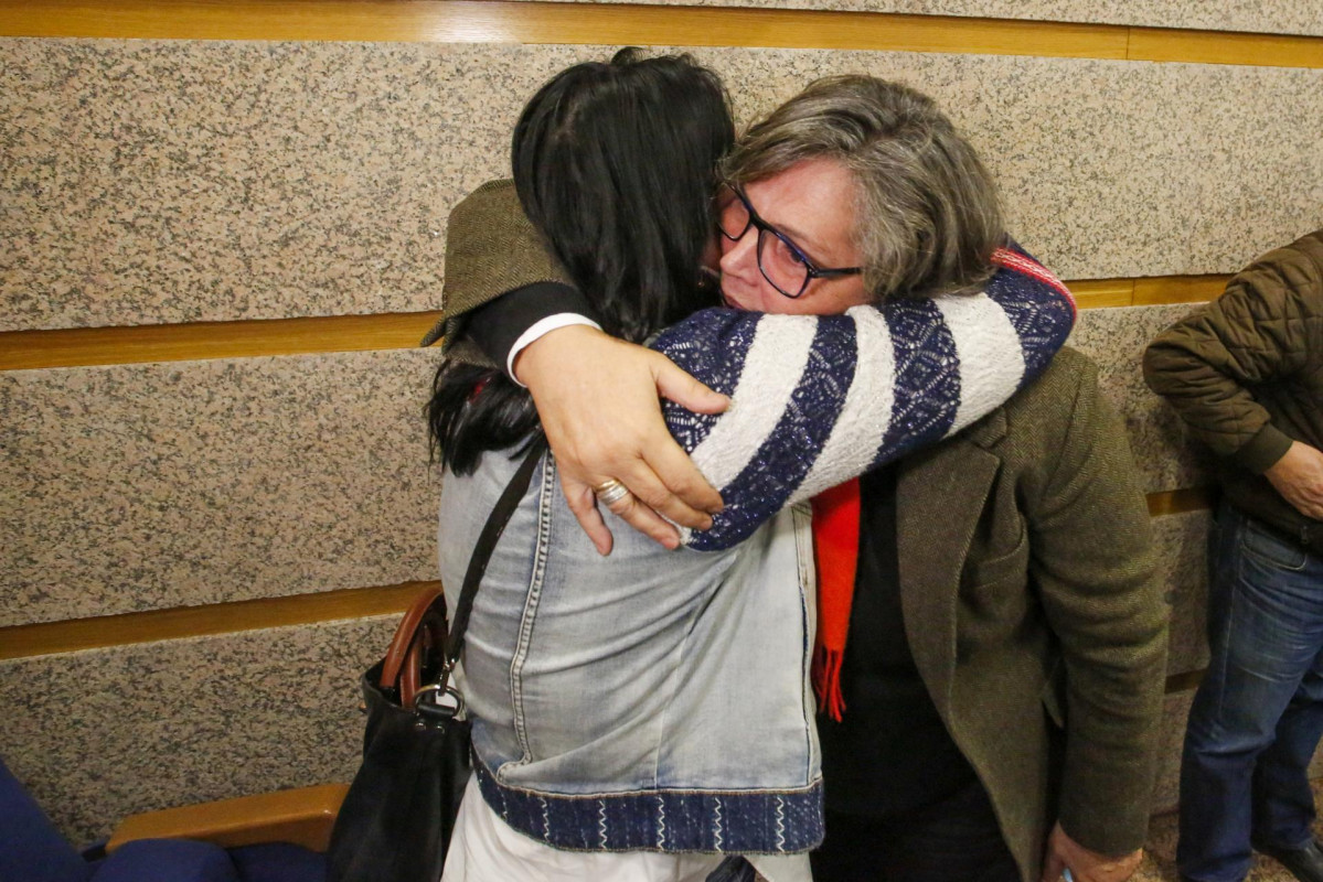 La alcaldesa de O Porriño, Eva García De la Torre (d), se abraza a una mujer a su llegada a una comparecencia para anunciar su dimisión, en el Salón de sesiones del Ayuntamiento, a 23 de noviembre