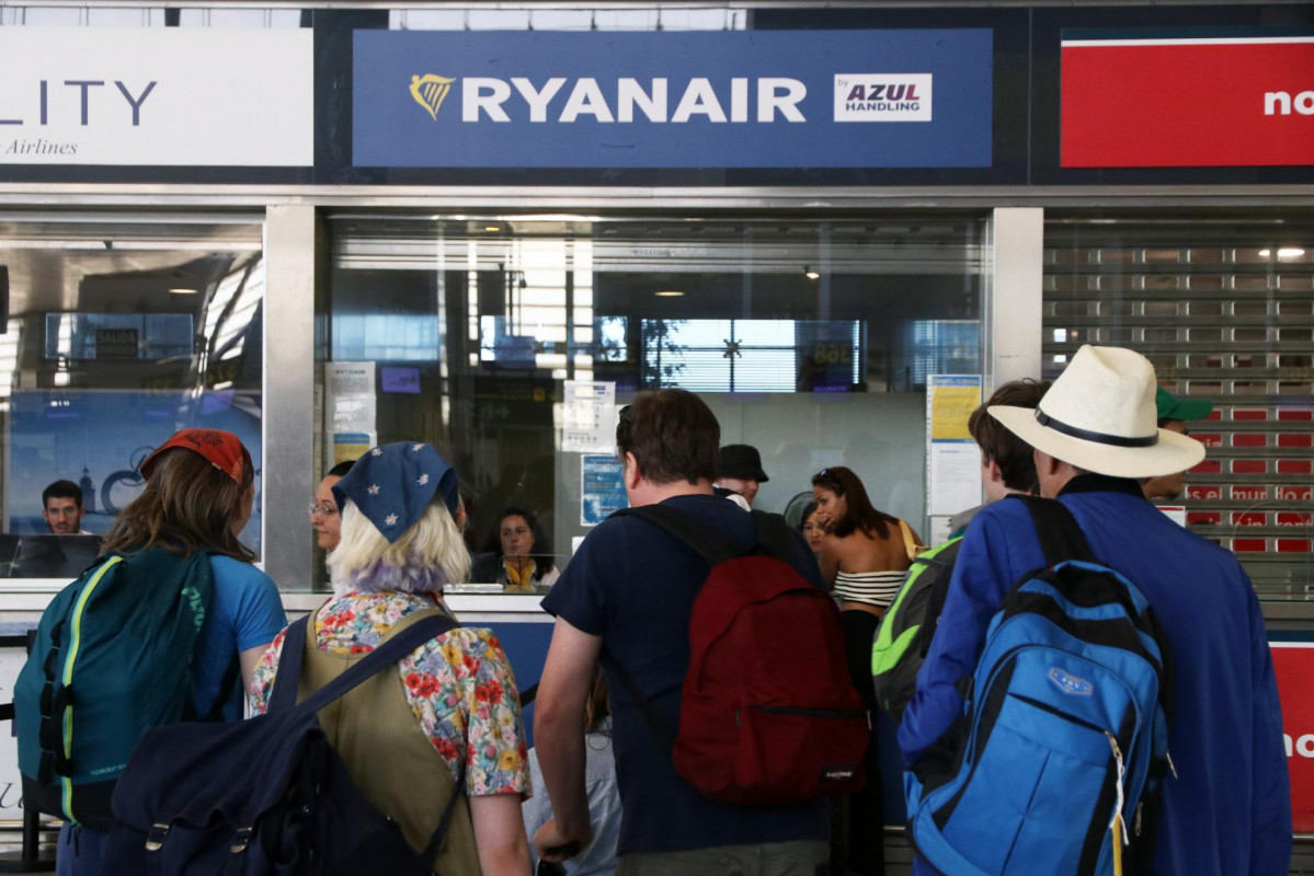 Varias personas se acercan a las ventanillas de la compañía aérea Ryanair que durante estos días los trabajadores de dicha empresa están huelga por sus condiciones laborales en el aeropuerto Cost