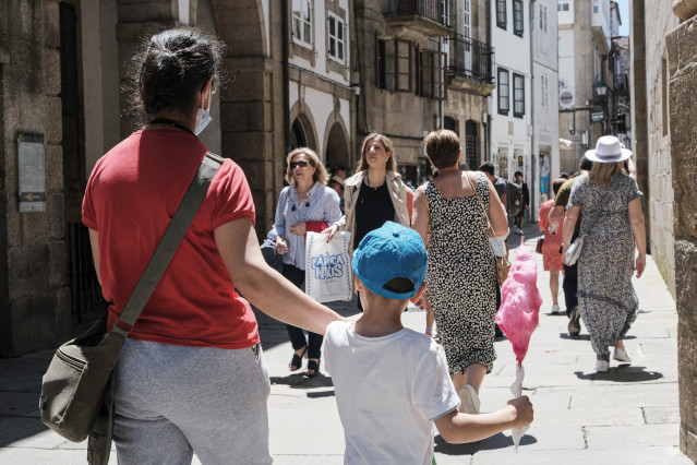 Archivo - Varias mujeres y un niño, con algodón de azúcar, pasean por Santiago de Compostela.