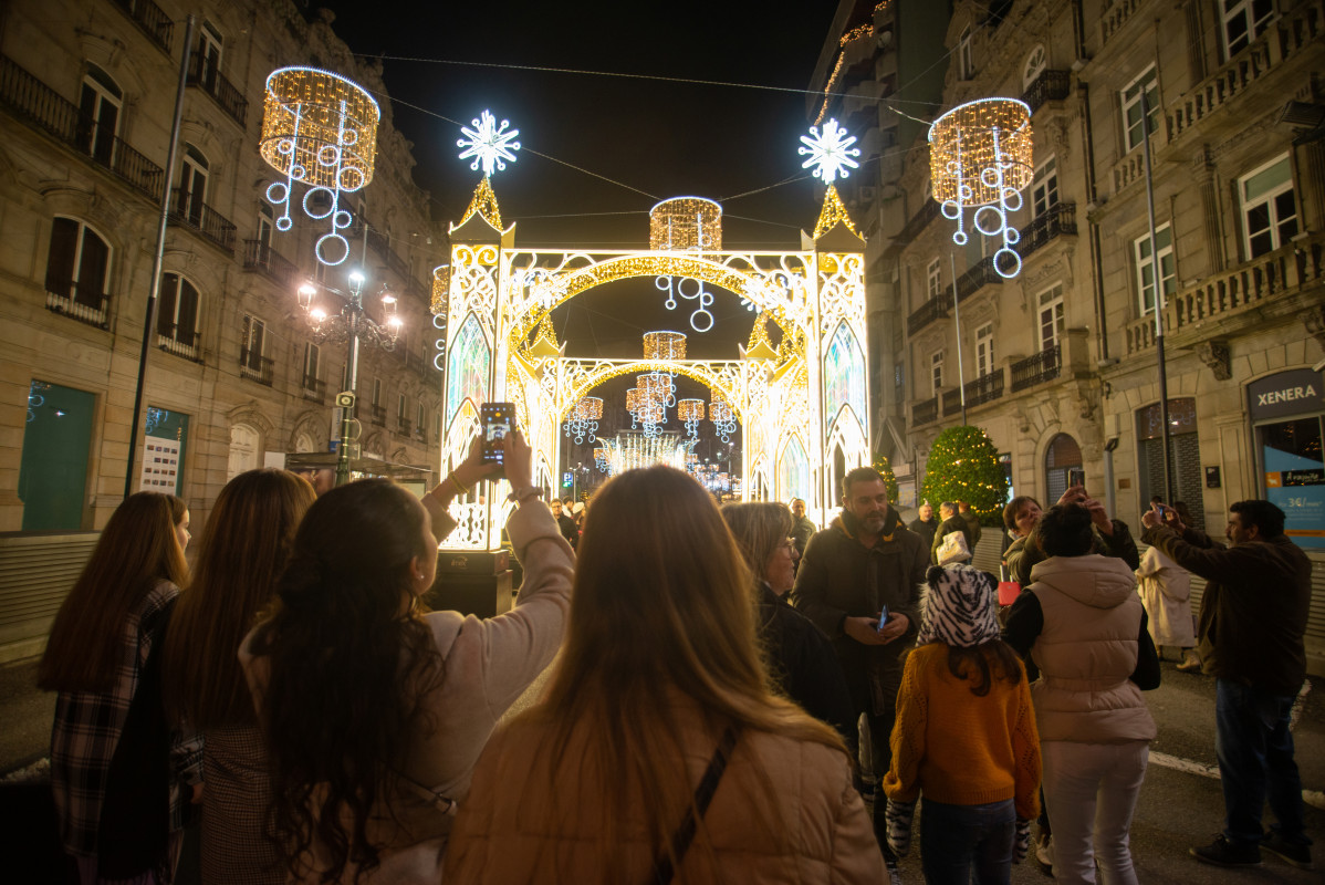 Varias personas pasean por el centro de la ciudad de Vigo para disfrutar de la iluminación navideña.