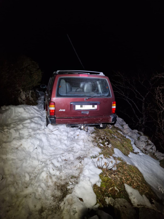 Coche atrapado en una pista forestal por la nieve
