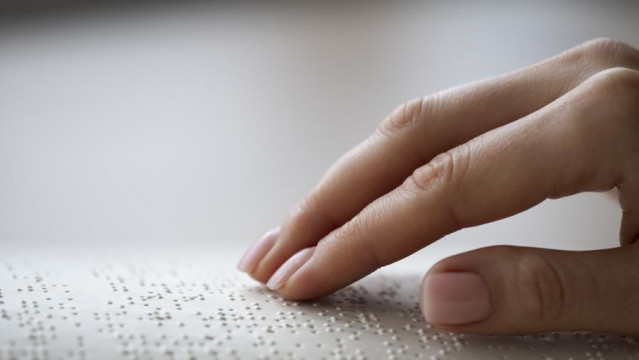 Una persona hace lectura en braille.