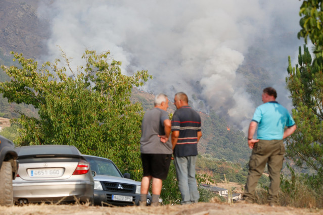 Varias personas observan el fuego, a 17 de agosto de 2025, en Quiroga, Lugo