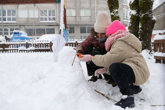 Unos niños juegan con la nieve, a 28 de enero de 2026, en Lugo, Galicia.